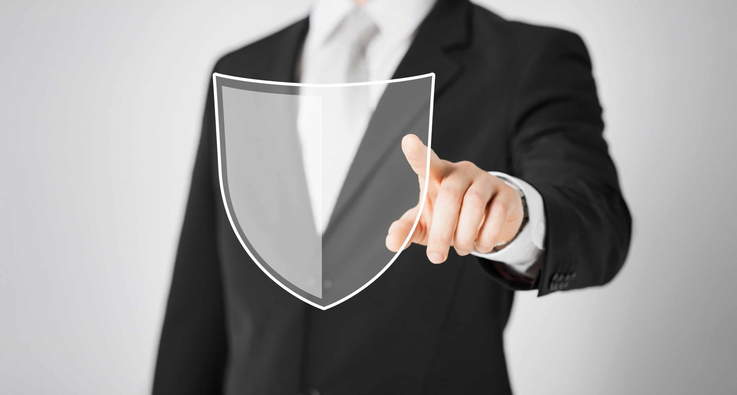 business, people and cyber protection concept - close up of man pointing his finger at virtual antivirus program shield icon over gray background